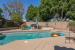 Large backyard area w/ patio seating, swimming pool and spa w/ optional heating, and BBQ